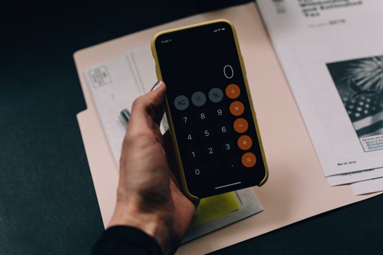 Accredited Debt Relief vs National Debt Relief comparison — calculator and financial paperwork