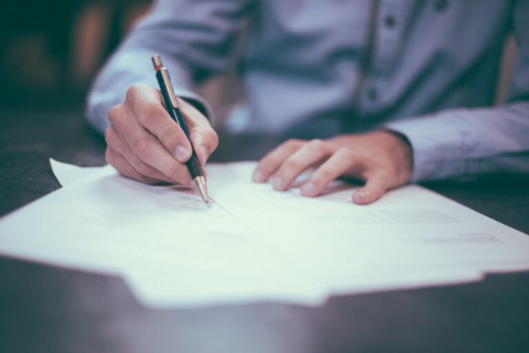 Debt settlement vs bankruptcy — weighing two debt relief options with paperwork and a calculator