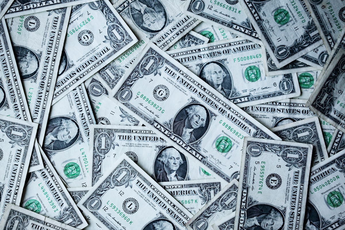Comparing debt relief programs in Georgia with a calculator and dollar bills